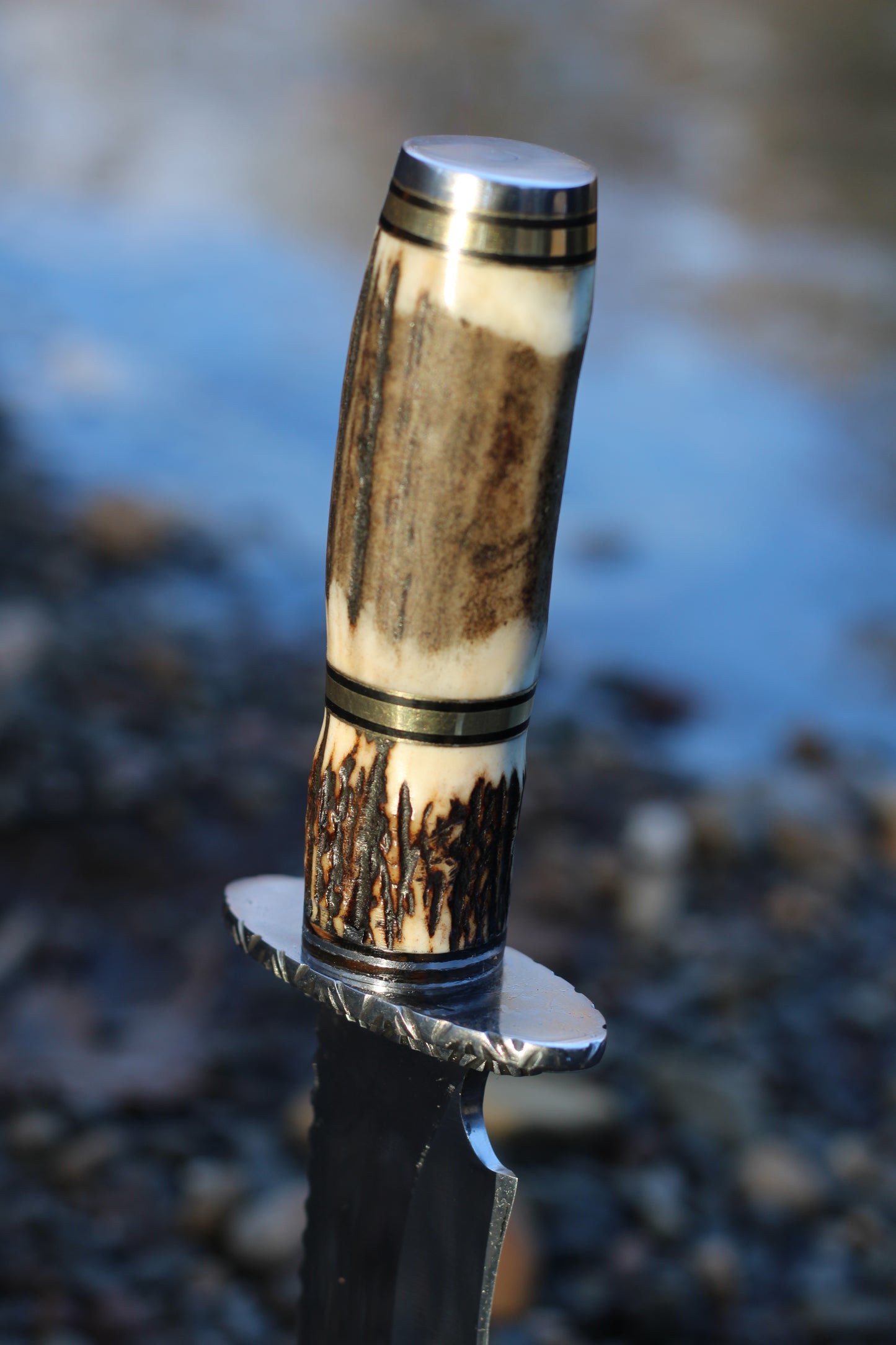 Stingmarrow’s Handcrafted Stainless Steel Hunting Knife with Genuine Deer Antler molded into an exclusive handle.