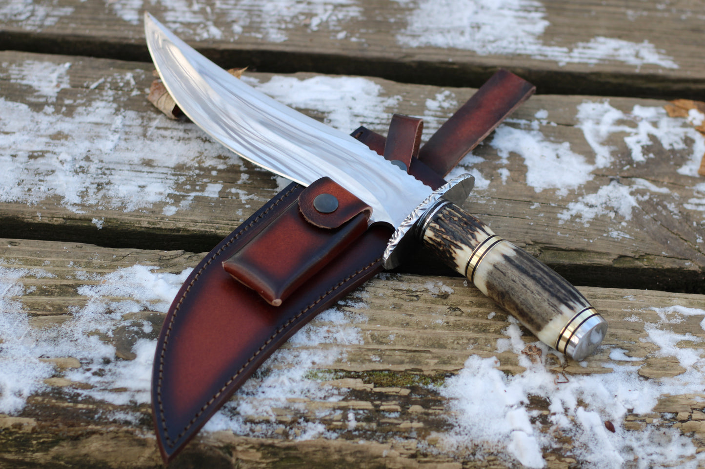 Stingmarrow’s Handcrafted Stainless Steel Hunting Knife with Genuine Deer Antler molded into an exclusive handle.