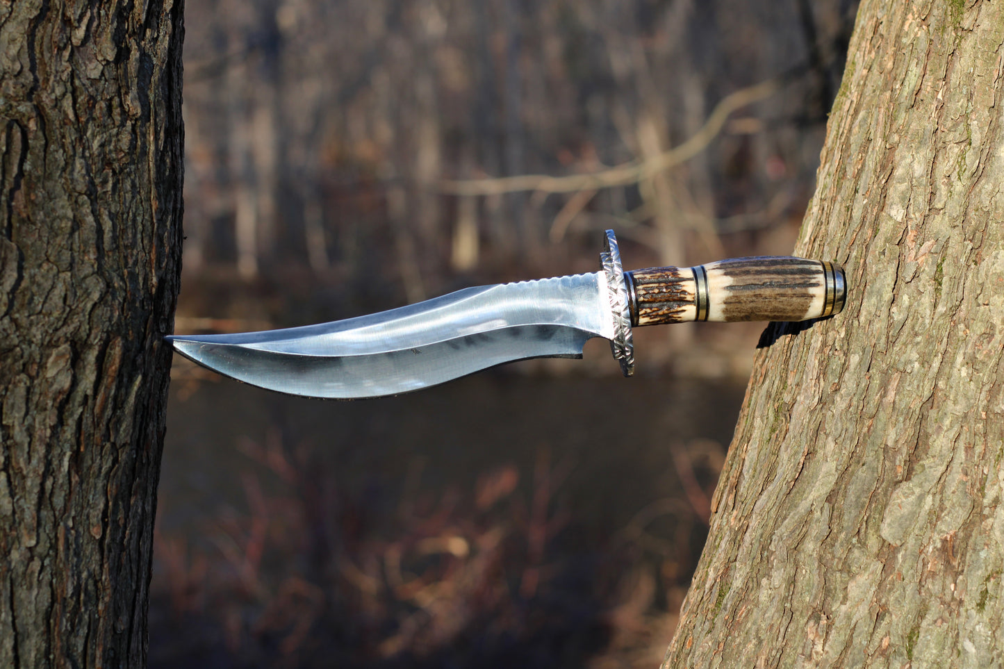 Stingmarrow’s Handcrafted Stainless Steel Hunting Knife with Genuine Deer Antler molded into an exclusive handle.